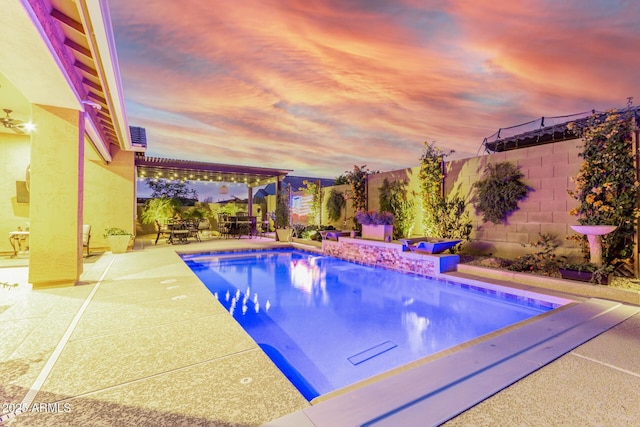 pool at dusk with a patio