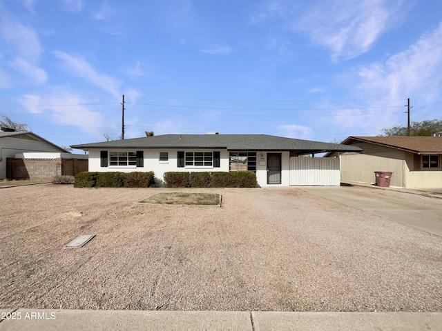 single story home featuring fence