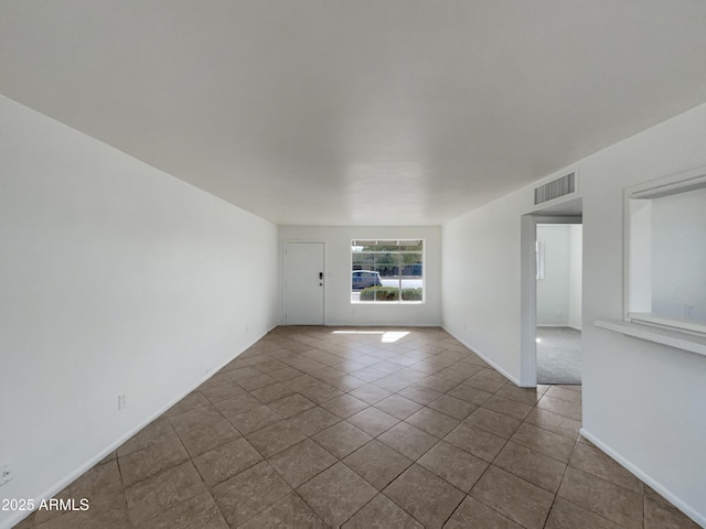 tiled spare room with visible vents