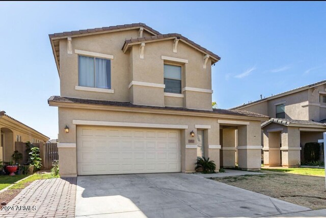 7117 W Globe Ave, Phoenix, AZ 85043 - traditional-style house featuring an attached garage, stucco siding, and concrete driveway