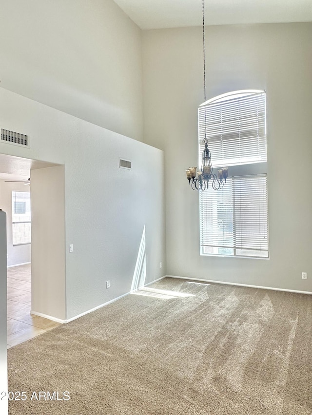 7117 W Globe Ave, Phoenix, AZ 85043 - unfurnished room featuring carpet floors, an inviting chandelier, and visible vents