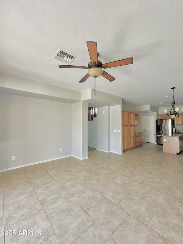 7117 W Globe Ave, Phoenix, AZ 85043 - unfurnished living room with baseboards, ceiling fan with notable chandelier, a textured ceiling, and visible vents
