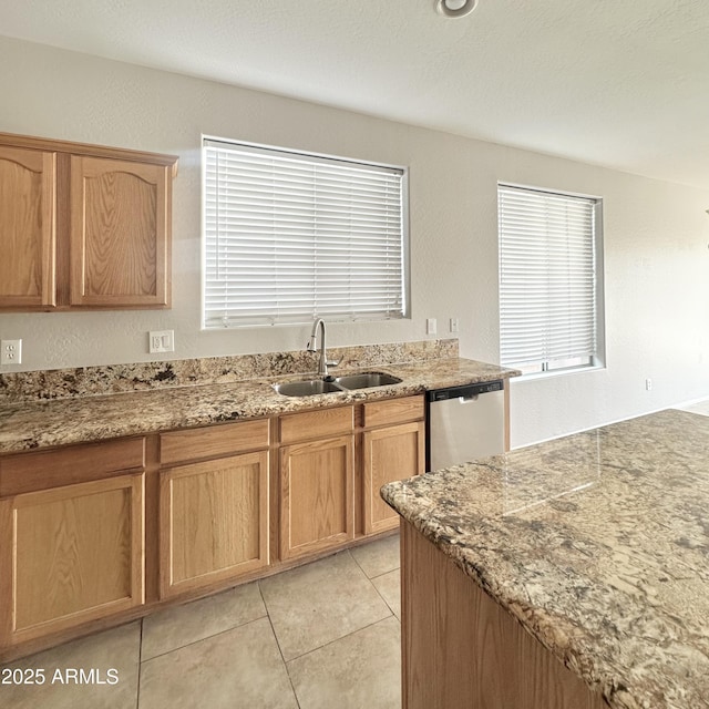 7117 W Globe Ave, Phoenix, AZ 85043 - kitchen featuring stainless steel dishwasher, a sink, light tile patterned floors, and light stone counters