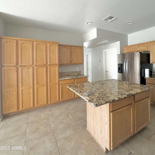 7117 W Globe Ave, Phoenix, AZ 85043 - kitchen featuring light stone countertops, visible vents, light tile patterned floors, and stainless steel fridge with ice dispenser