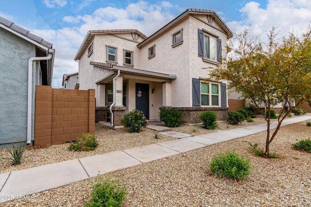 view of front of property featuring stucco siding and fence