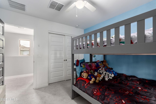 carpeted bedroom featuring a ceiling fan, baseboards, visible vents, and a closet