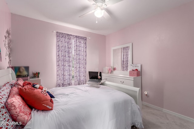 bedroom with baseboards, light colored carpet, and a ceiling fan