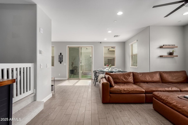 living area with wood finished floors, visible vents, baseboards, recessed lighting, and ceiling fan