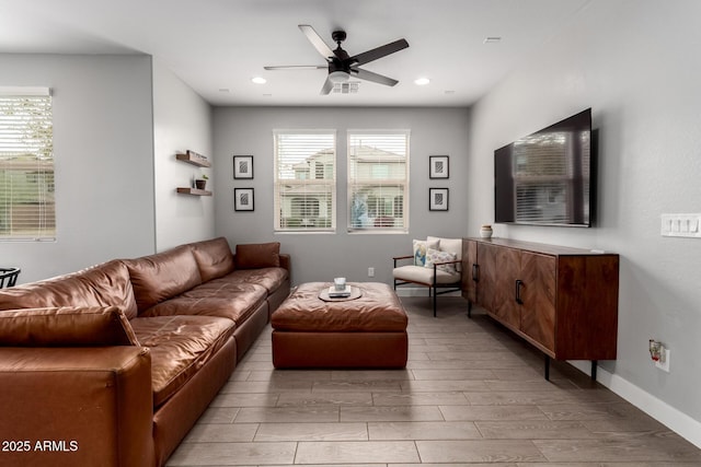 living area with plenty of natural light, visible vents, a ceiling fan, and wood finish floors