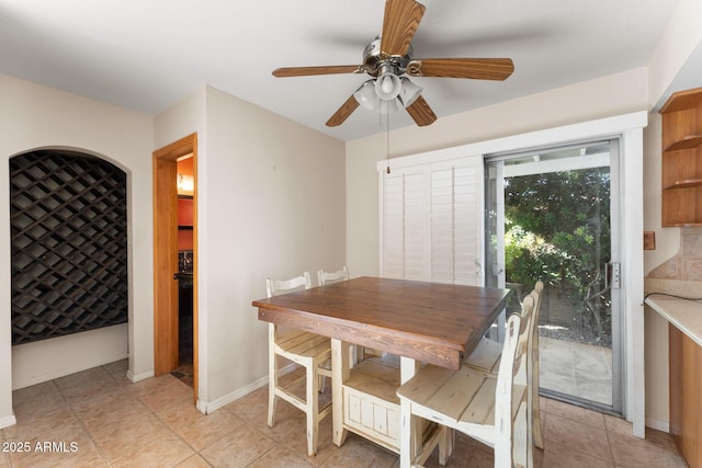 dining area featuring light tile patterned floors and ceiling fan