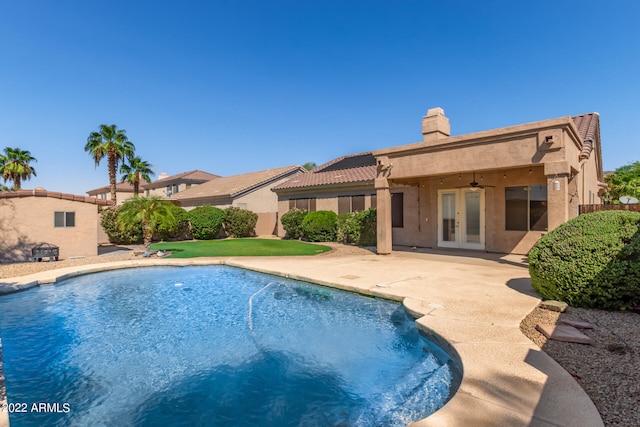 view of pool with a patio area, ceiling fan, and french doors