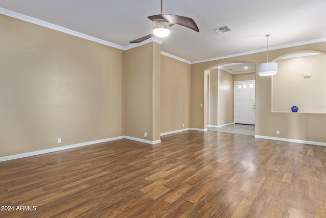 spare room featuring ceiling fan, ornamental molding, and wood-type flooring