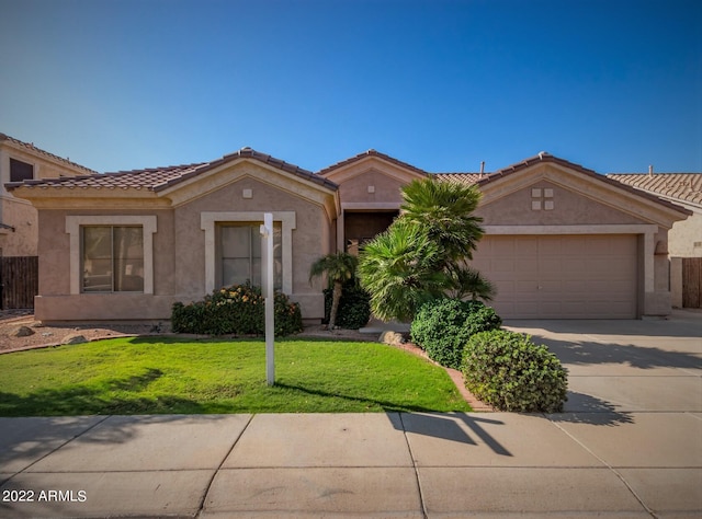 view of front of house featuring a garage and a front yard