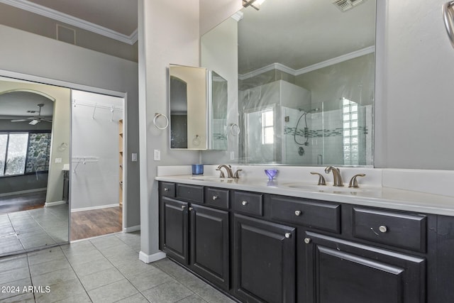 bathroom with walk in shower, crown molding, vanity, ceiling fan, and tile patterned flooring