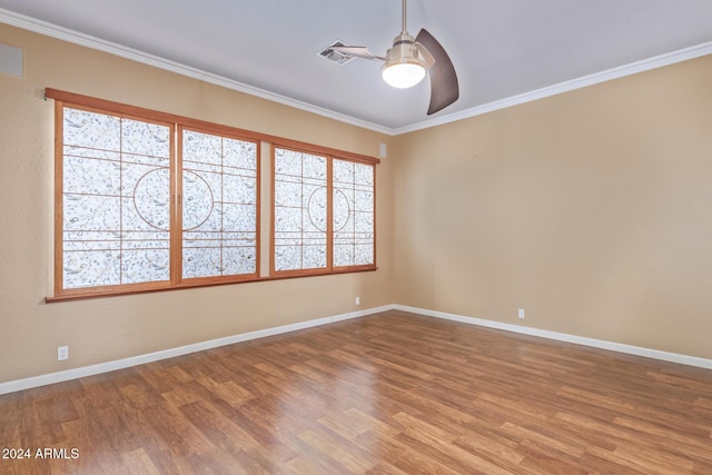 empty room with crown molding, ceiling fan, and hardwood / wood-style floors