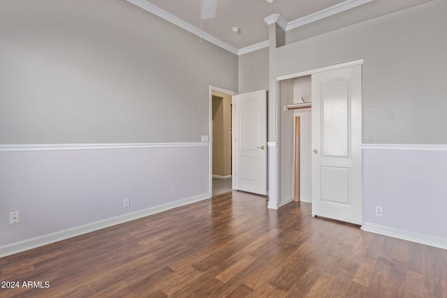 unfurnished bedroom with crown molding, ceiling fan, dark hardwood / wood-style floors, and a closet