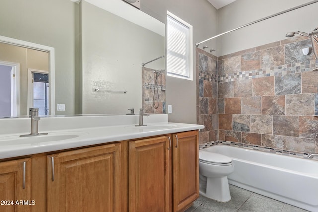 full bathroom featuring vanity, tiled shower / bath, tile patterned floors, and toilet