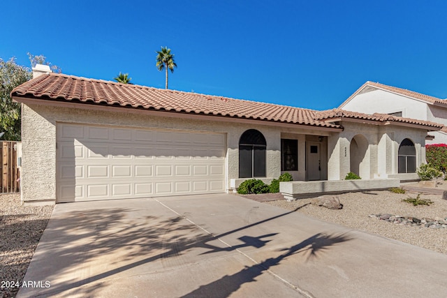 mediterranean / spanish-style house featuring a garage