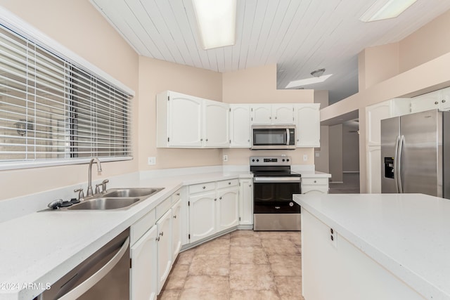 kitchen with white cabinetry, sink, vaulted ceiling, and appliances with stainless steel finishes