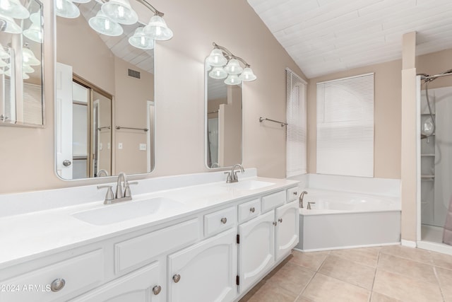 bathroom with tile patterned flooring, vanity, lofted ceiling, and shower with separate bathtub