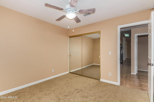 unfurnished bedroom featuring ceiling fan, a closet, and carpet