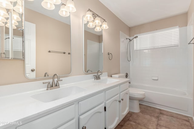 full bathroom featuring vanity, toilet, and tiled shower / bath