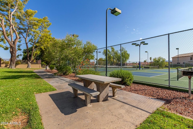 view of home's community with tennis court