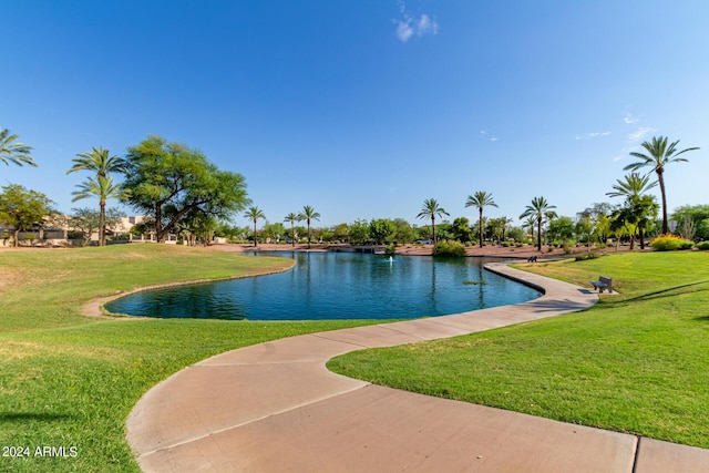 view of pool featuring a yard and a water view