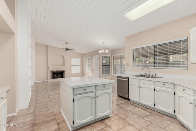 kitchen with white cabinetry, sink, stainless steel dishwasher, and decorative light fixtures