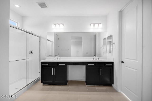 bathroom with tile patterned floors, vanity, and an enclosed shower