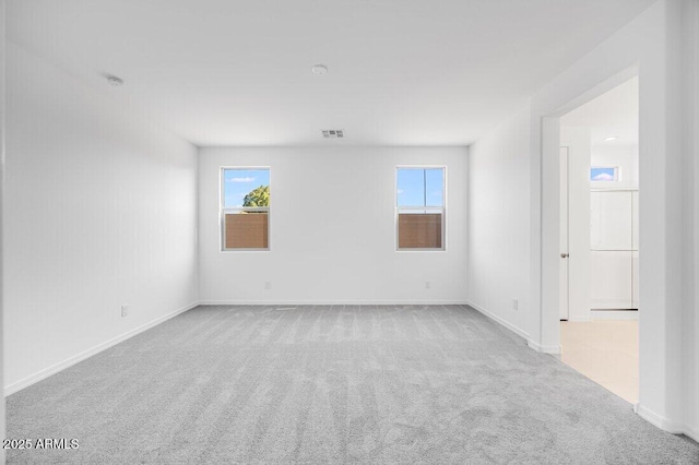 carpeted empty room featuring plenty of natural light