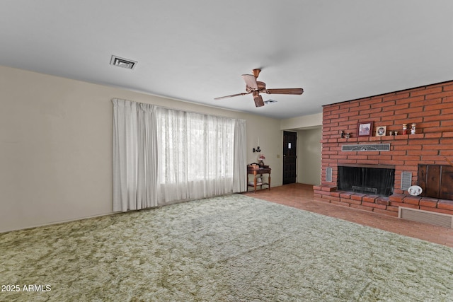 1455 W Kenrick Dr, Wickenburg, AZ 85390 - unfurnished living room featuring carpet, a ceiling fan, and a fireplace