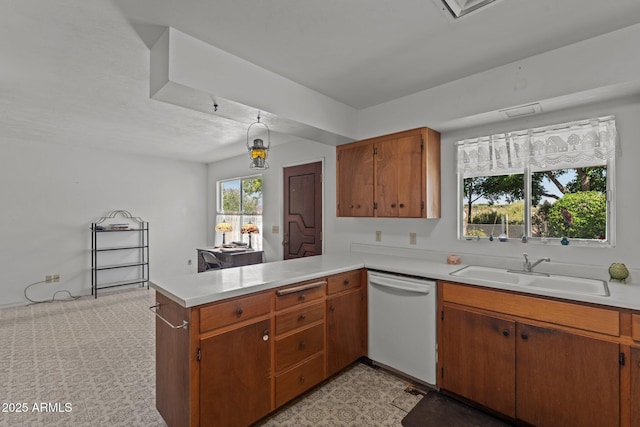 1455 W Kenrick Dr, Wickenburg, AZ 85390 - kitchen featuring white dishwasher, a peninsula, light countertops, and brown cabinetry