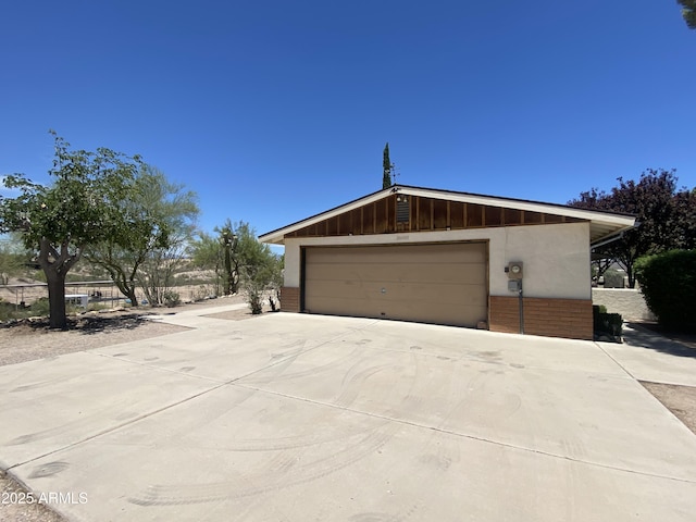 1455 W Kenrick Dr, Wickenburg, AZ 85390 - view of property exterior with brick siding and a detached garage
