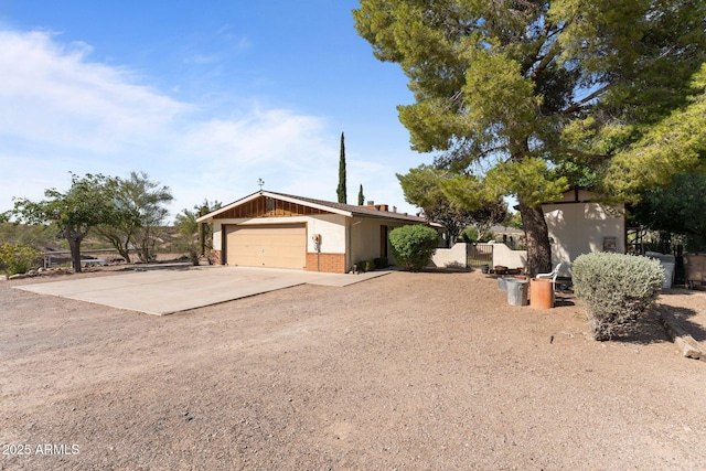 1455 W Kenrick Dr, Wickenburg, AZ 85390 - view of property exterior featuring concrete driveway, brick siding, and an attached garage