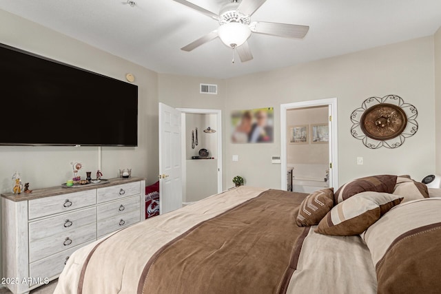 bedroom with ceiling fan, visible vents, and ensuite bathroom