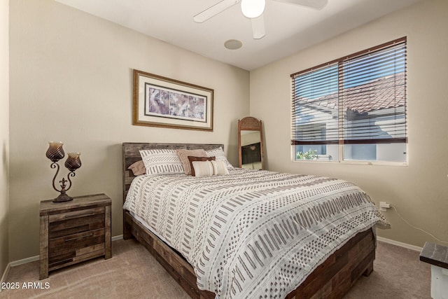 bedroom with a ceiling fan, baseboards, and carpet flooring