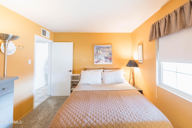 bedroom featuring light colored carpet