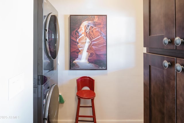 laundry room with stacked washer / drying machine