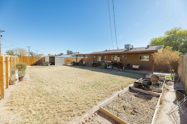 view of yard featuring a storage shed and central AC