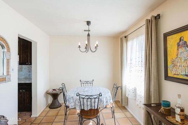 tiled dining space with a chandelier