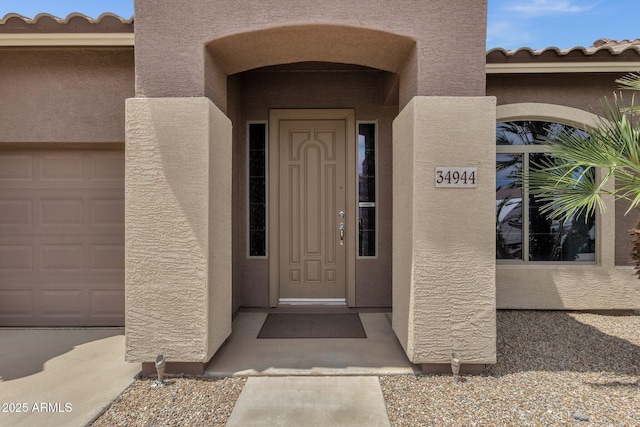 34944 N Mirandesa Dr, San Tan Valley, AZ 85143 - view of exterior entry featuring stucco siding and a tile roof