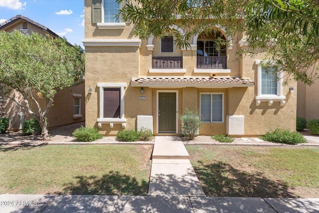4212 E Jasper Dr, Gilbert, AZ 85296 - view of property featuring stucco siding, a balcony, a tile roof, and a front lawn