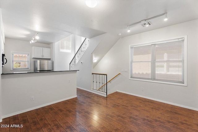 4212 E Jasper Dr, Gilbert, AZ 85296 - unfurnished living room with track lighting and dark wood-style flooring