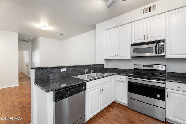 4212 E Jasper Dr, Gilbert, AZ 85296 - kitchen with stainless steel appliances, dark wood-type flooring, white cabinetry, and a peninsula