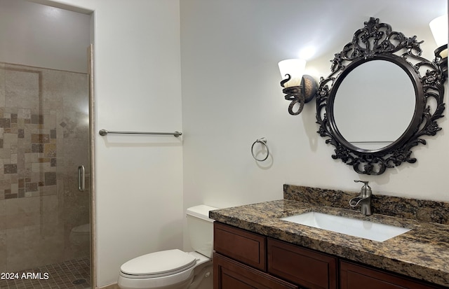 bathroom with walk in shower, vanity, and toilet