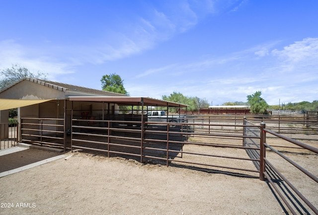 view of horse barn featuring a rural view