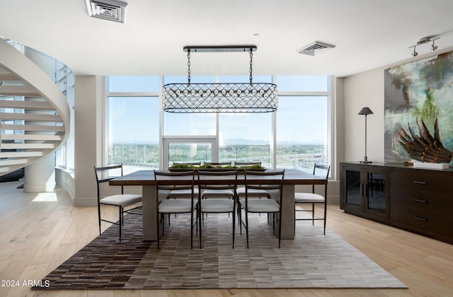 dining room featuring a wealth of natural light and light hardwood / wood-style flooring