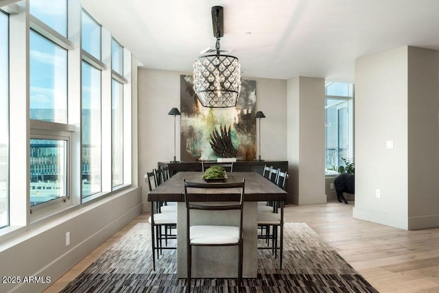 dining space featuring an inviting chandelier and light hardwood / wood-style floors