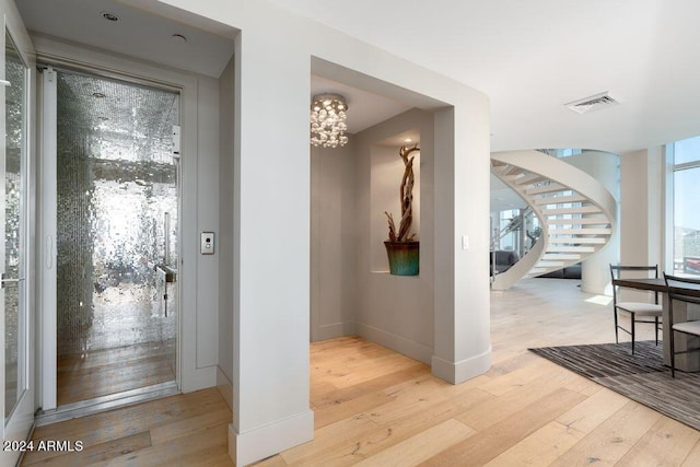 hallway with light hardwood / wood-style floors